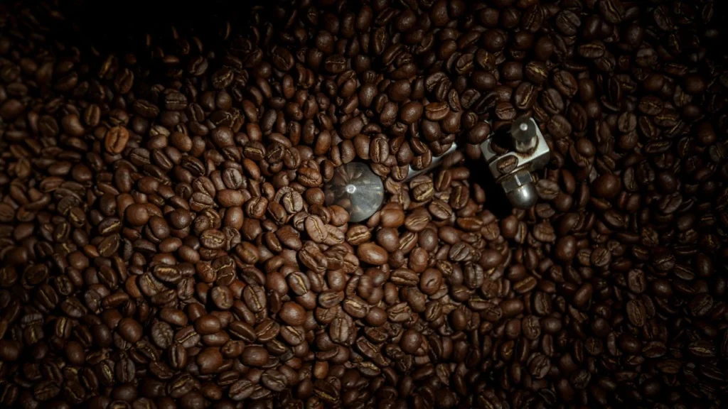 Roasted coffee beans inside a roasting drum at Bali Origins, showing even color and controlled roast development.