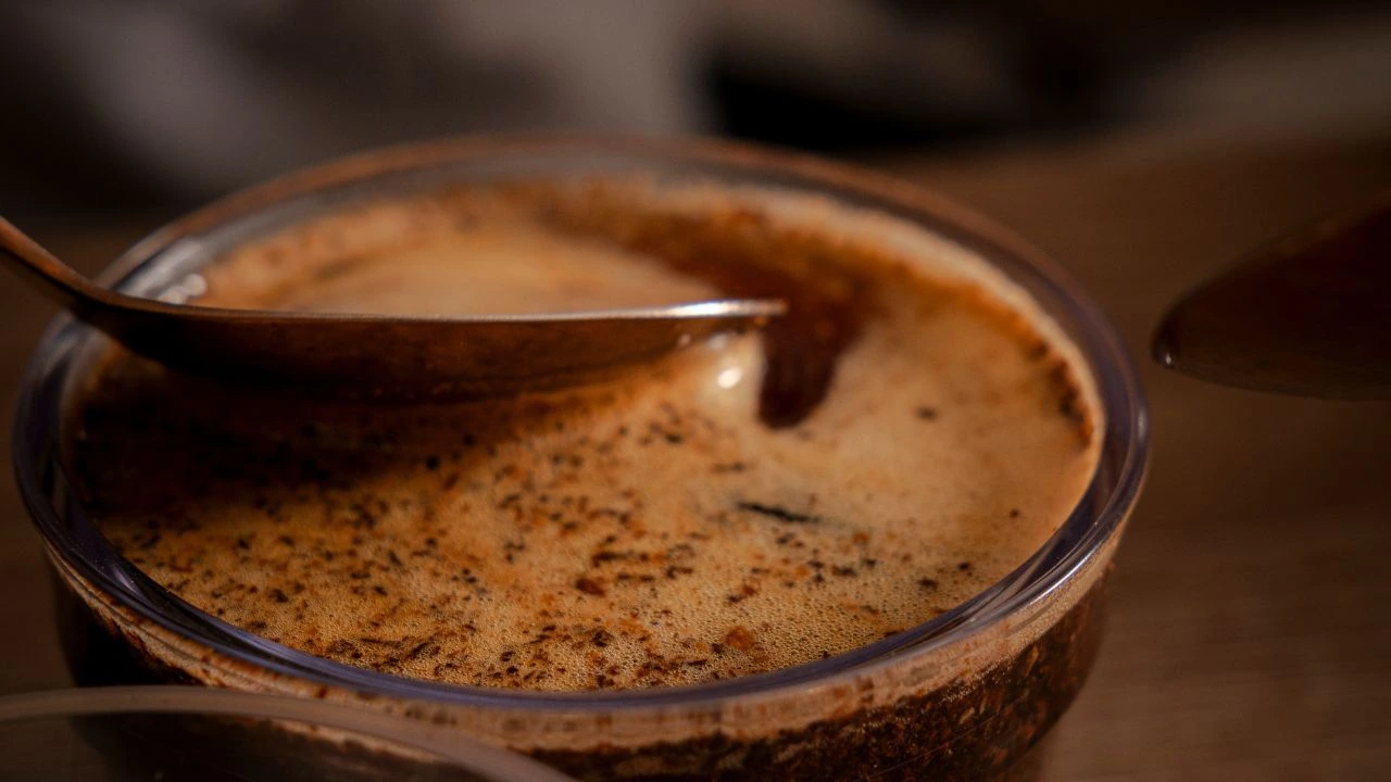 Freshly brewed coffee at Bali Origins during quality evaluation, highlighting foam, surface texture, and extraction.