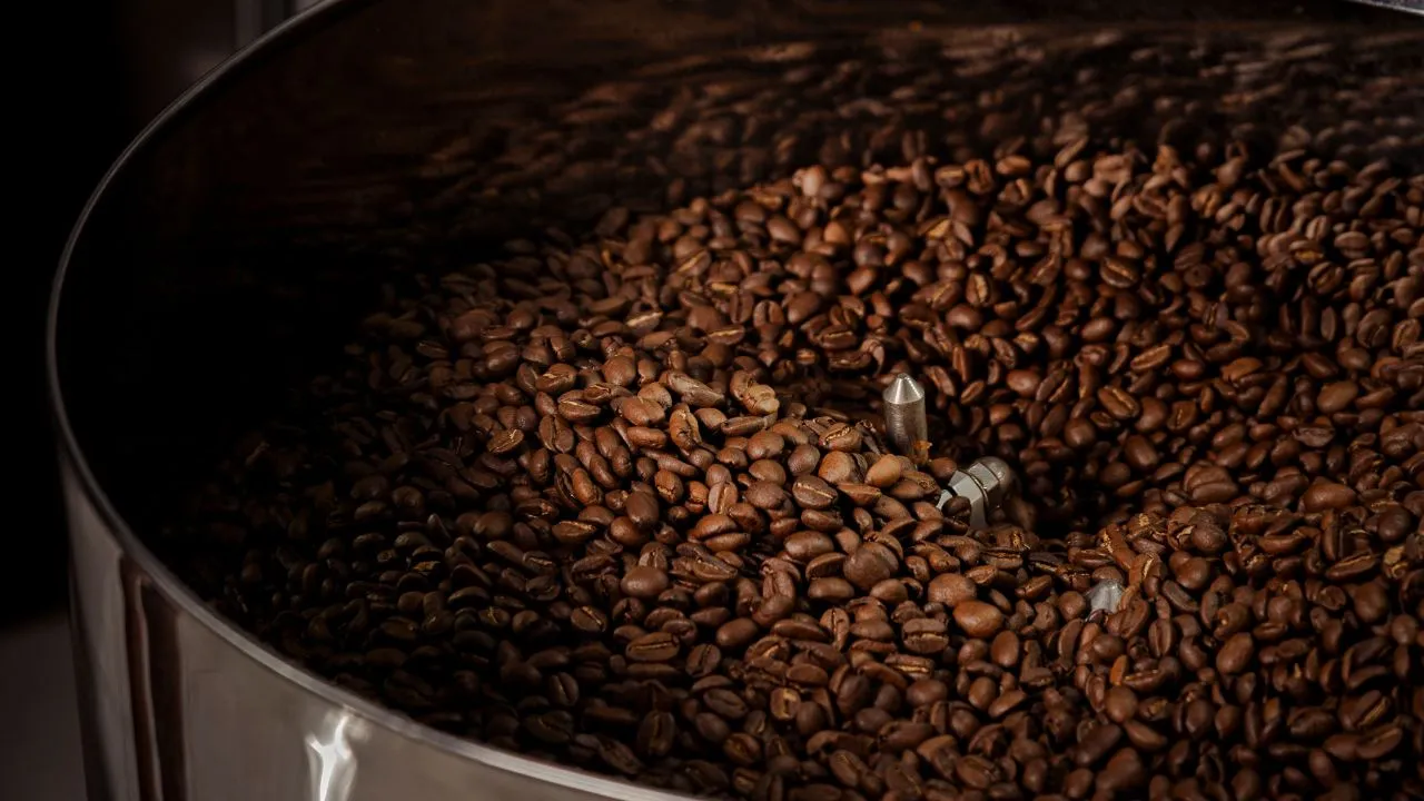 Coffee beans inside a roasting drum at Bali Origins, highlighting controlled roasting and consistent batch quality.