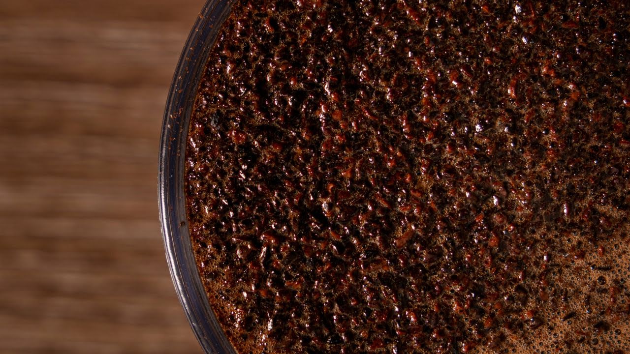 Close-up of freshly brewed Robusta coffee at Bali Origins, highlighting its dense body, dark crema, and strong extraction profile.
