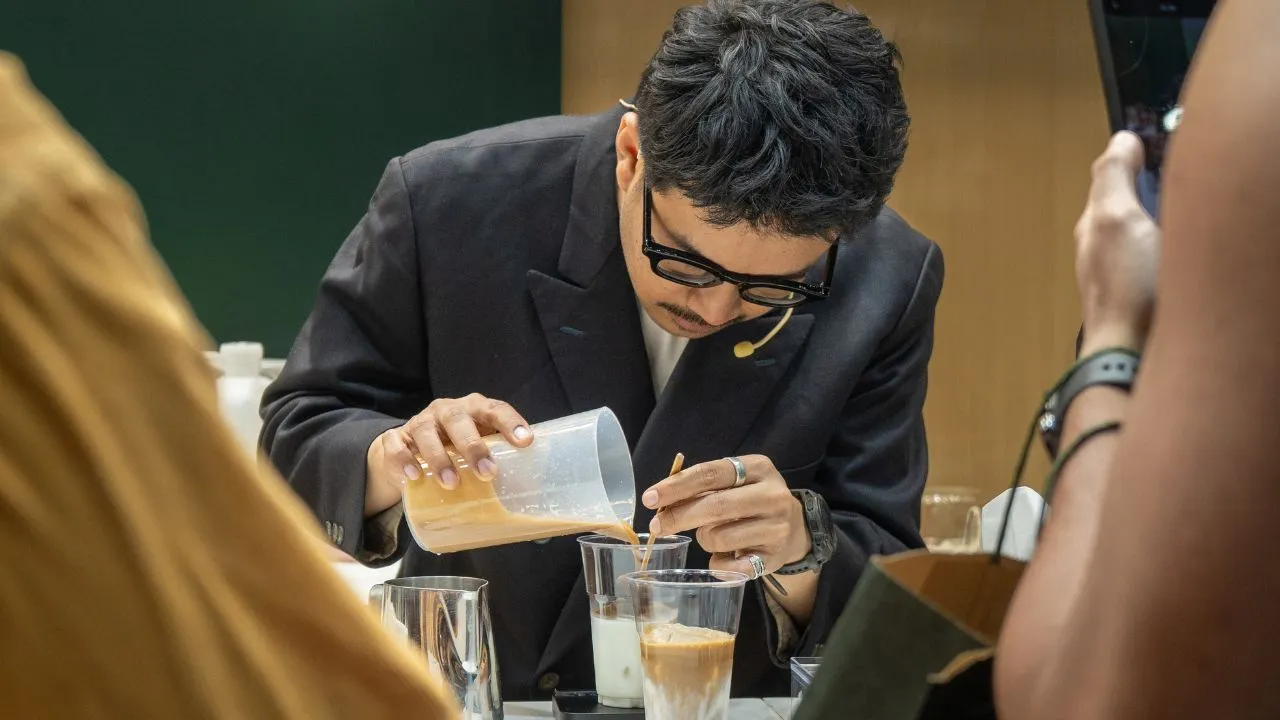 Muhammad Aga, 2025 World Espresso Champion and two-time Indonesian Barista Champion, leading coffee brewing and presentation at the Bali Origins booth.