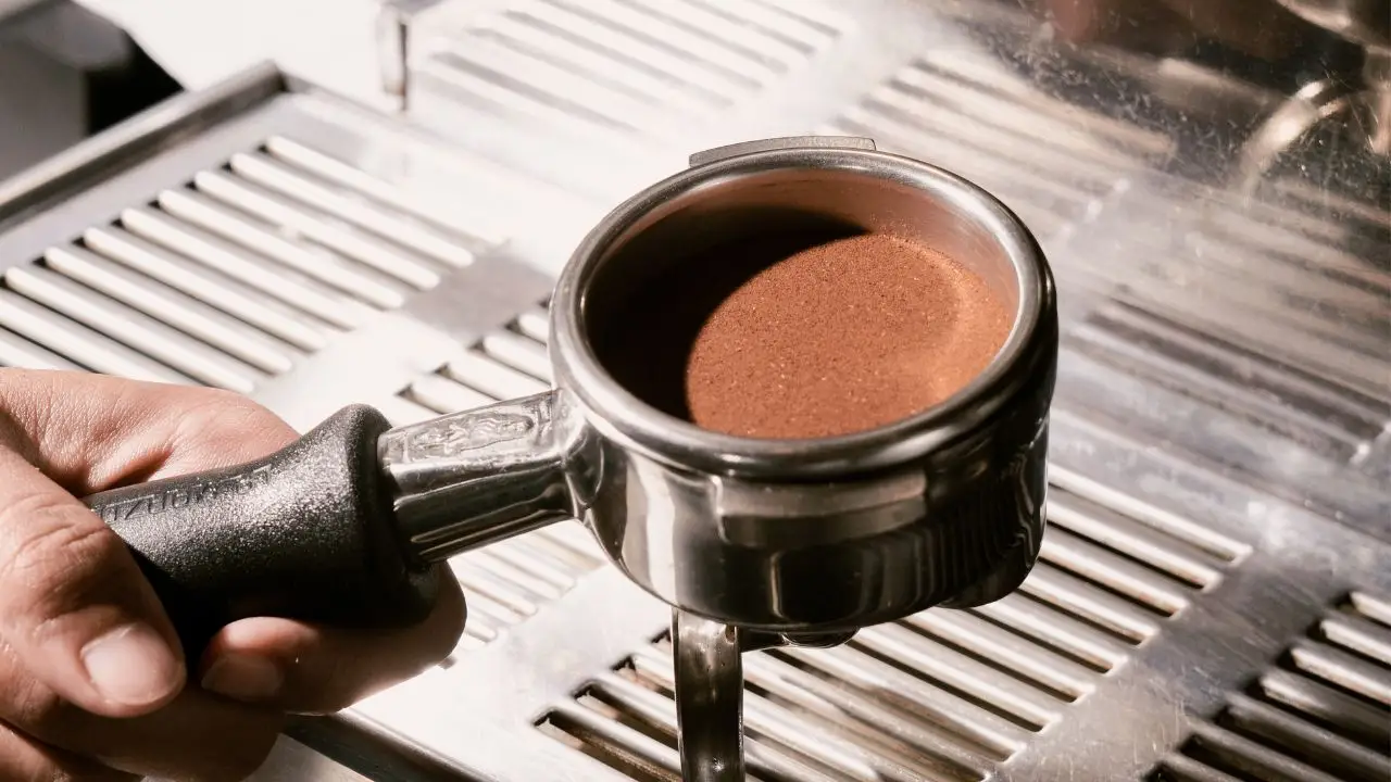 Ground coffee prepared for espresso extraction as part of Bali Origins coffee and roasting quality control process for commercial consistency.