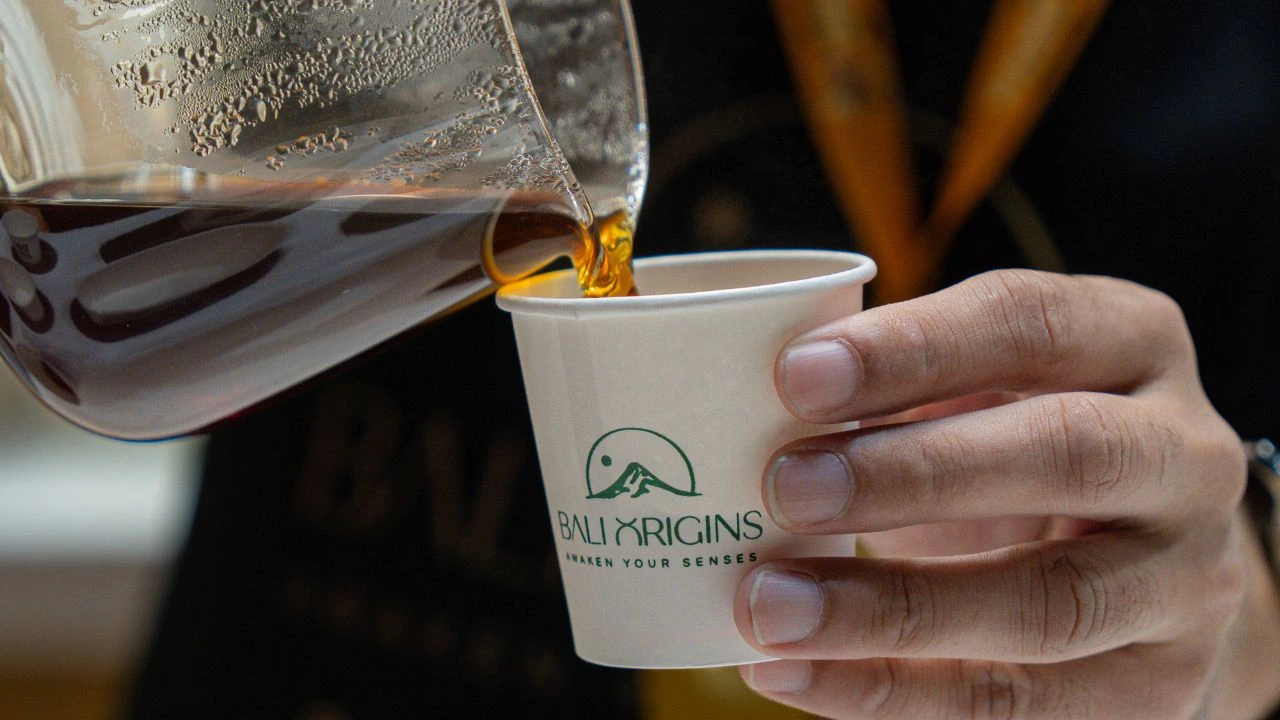 Pouring freshly brewed Arabica coffee into a Bali Origins cup.
